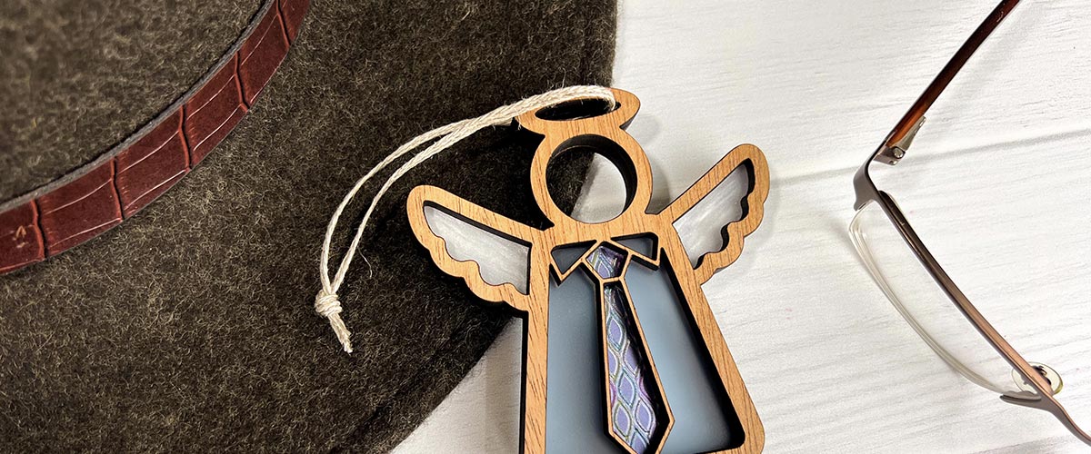 Father's Day gift ideas - Stylish Forged Flare® Mother's Angels® ornament, an ideal Father's Day gift from daughter and for first-time dads, displayed alongside fashionable accessories.