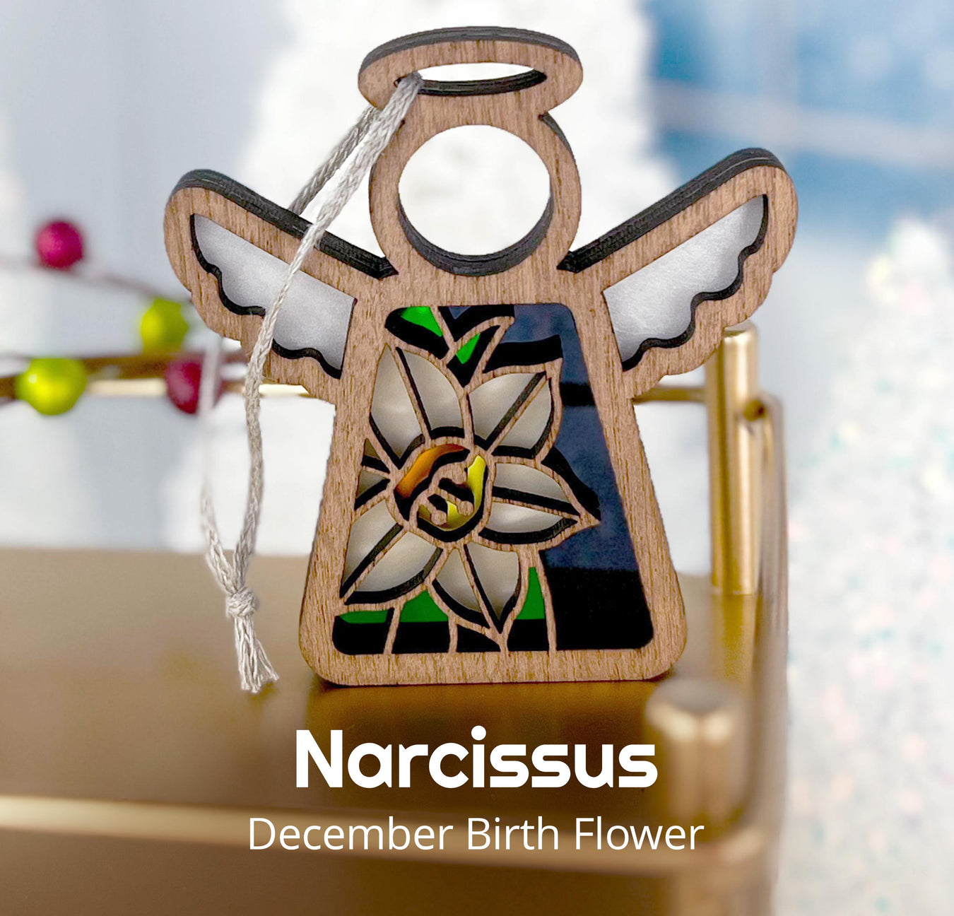 A Forged Flare® Christmas angel ornament with the December birth flower Narcissus, perfect as a Christmas present and a thoughtful addition to anyone's Christmas gifts.