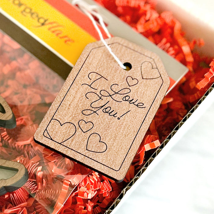 A lovingly handcrafted "I Love You" gift tag on a present, perfect for accompanying your gift ideas and celebrating the occasion. 