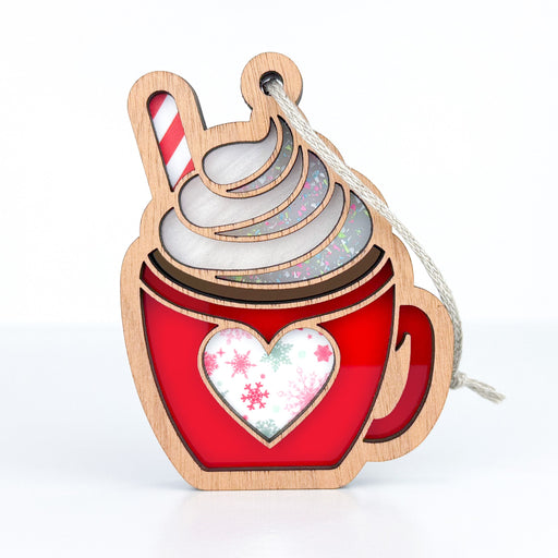 Embrace the festive spirit with the Holiday Hot Cocoa Coffee Mug Ornament, 3.5” by Forged Flare®. This delightful ornament, shaped like a red mug brimming with swirled whipped cream and garnished with a candy cane, is beautifully adorned with a heart and snowflakes, making it an ideal addition to your coffee bar decoration.