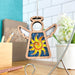 The Celestial Sun Ornament, a 3.5" angel figurine from the Mother's Angels® collection by Forged Flare®, features a wooden angel with a halo and wings. It displays a colorful design in the center, showcasing a bright yellow sun against a blue glittery background. This charming Christmas ornament hangs beautifully in a cozy, well-lit room surrounded by plants, books, and pencils.