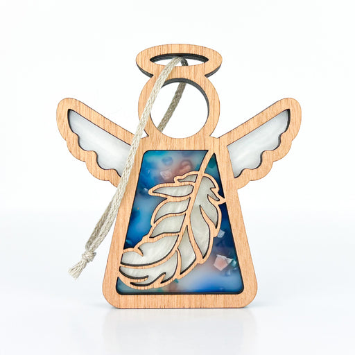 The Forged Flare® Mother's Angels® Feather Ornament is a 3.5" wooden angel figurine with intricately designed wings and a halo. It features a blue section on the body with an elegant feather design and comes equipped with a braided linen string at the top for easy hanging. The ornament is displayed against a plain white background.