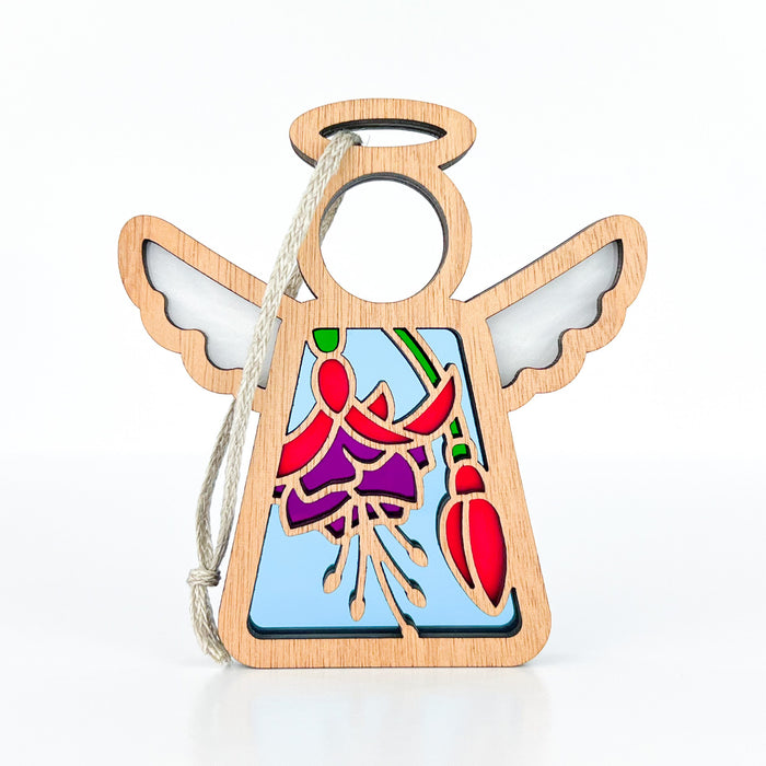 The Fuchsia Ornament by Forged Flare® is a 3.5" angel figurine from the Mother's Angels® collection. This wooden angel ornament features stained glass-style detailing, with outstretched wings, a halo, and a hanging loop made of string. The center showcases a colorful purple fuchsia flower design with shades of purple, red, and green on a light blue background—perfect as a Christmas tree ornament.