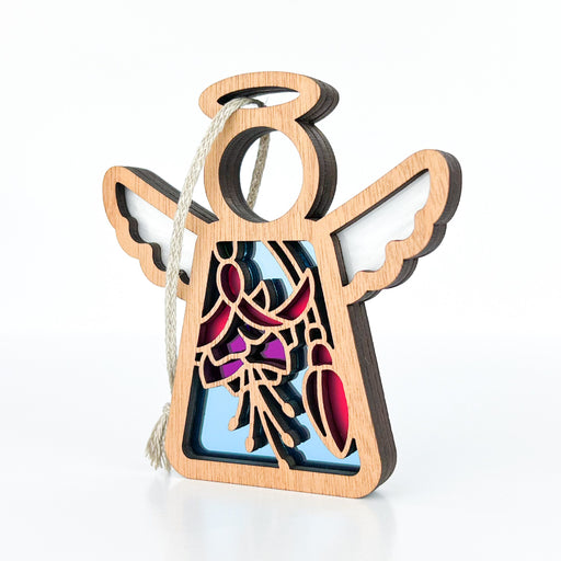 The Fuchsia Ornament by Forged Flare®, a 3.5" angel figurine from the Mother's Angels® collection, boasts intricate cut-out designs with a vibrant stained-glass effect in shades of blue, pink, and purple at its center. This wooden angel ornament featuring wings and a halo is perfect for adorning your Christmas tree and comes with a looped cord for easy hanging.