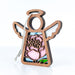 Introducing the Pink Peony Ornament, a 3.5" angel figurine from Mother's Angels® by Forged Flare®. This wooden angel-shaped ornament features intricately detailed wing designs and a stained glass-style cutout adorned with pink peonies and green leaves. A cord at the top makes it ideal for hanging as a Christmas tree ornament, while the plain white background enhances its elegant simplicity.