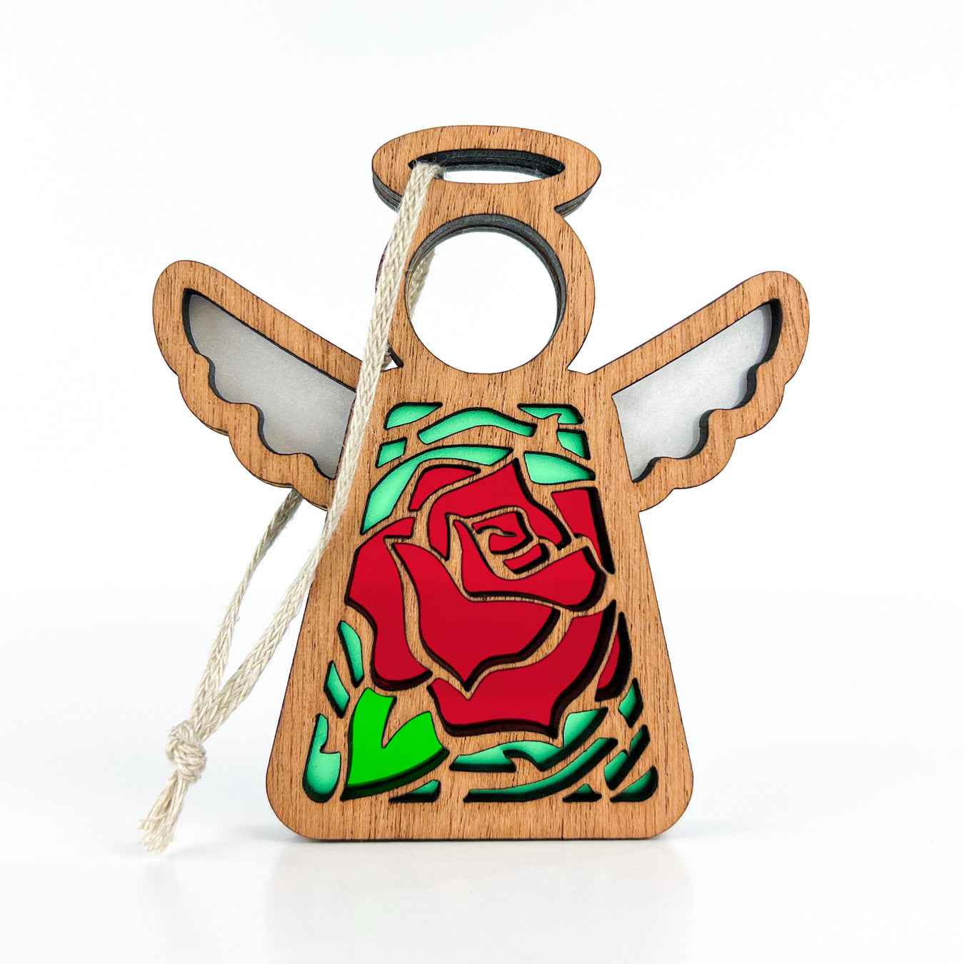 Discover the charm of the Forged Flare® Red Rose Ornament | 3.5" Angel Figurine from the Mother's Angels® collection. This wooden angel figurine features outstretched wings and a captivating cutout design showcasing a red rose birth flower with green leaves at its center. A braided linen string is attached, making it easy for hanging against its plain white background.