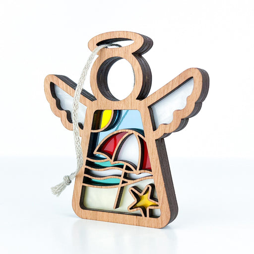 Introducing the Summer Beach Ornament from Forged Flare®! This 3.5" angel figurine, part of the Mother's Angels® collection, features delightful stained glass–style elements. The colorful stained glass–style sections depict a vibrant beach scene with a sun, umbrella, ocean waves, and a starfish. Perfect as a beach gift or for adding coastal charm to your Christmas tree, it includes a loop at the top with an attached hanging string.