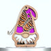 A wooden gnome ornament featuring a pink hat, a white beard, and a central cutout of an orange and black monarch butterfly. It has a string attached for easy hanging.