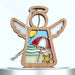 A wooden beach ornament angel with cutout wings and a halo. The body features a colorful beach scene with a red and white umbrella, blue waves, a yellow sun, and a starfish. A braided linen string is attached for hanging.